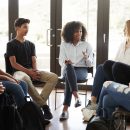 Female Tutor Leading Discussion Group Amongst High School Pupils