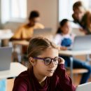 Schoolgirl,Using,Laptop,During,Computer,Class,At,Elementary,School.