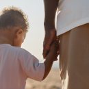 Father and Son Holding Hands Back View