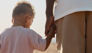 Father and Son Holding Hands Back View