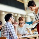 Group of college students studying at library