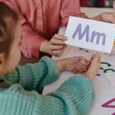 Schoolgirl learning English with teacher