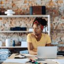 young-woman-sitting-at-table-using-laptop-2022-03-08-01-27-41-utc