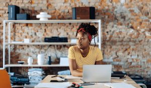 young-woman-sitting-at-table-using-laptop-2022-03-08-01-27-41-utc