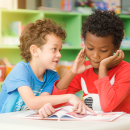 row-of-multiethnic-elementary-students-reading-book-in-classroom-vintage-effect-style-pictures